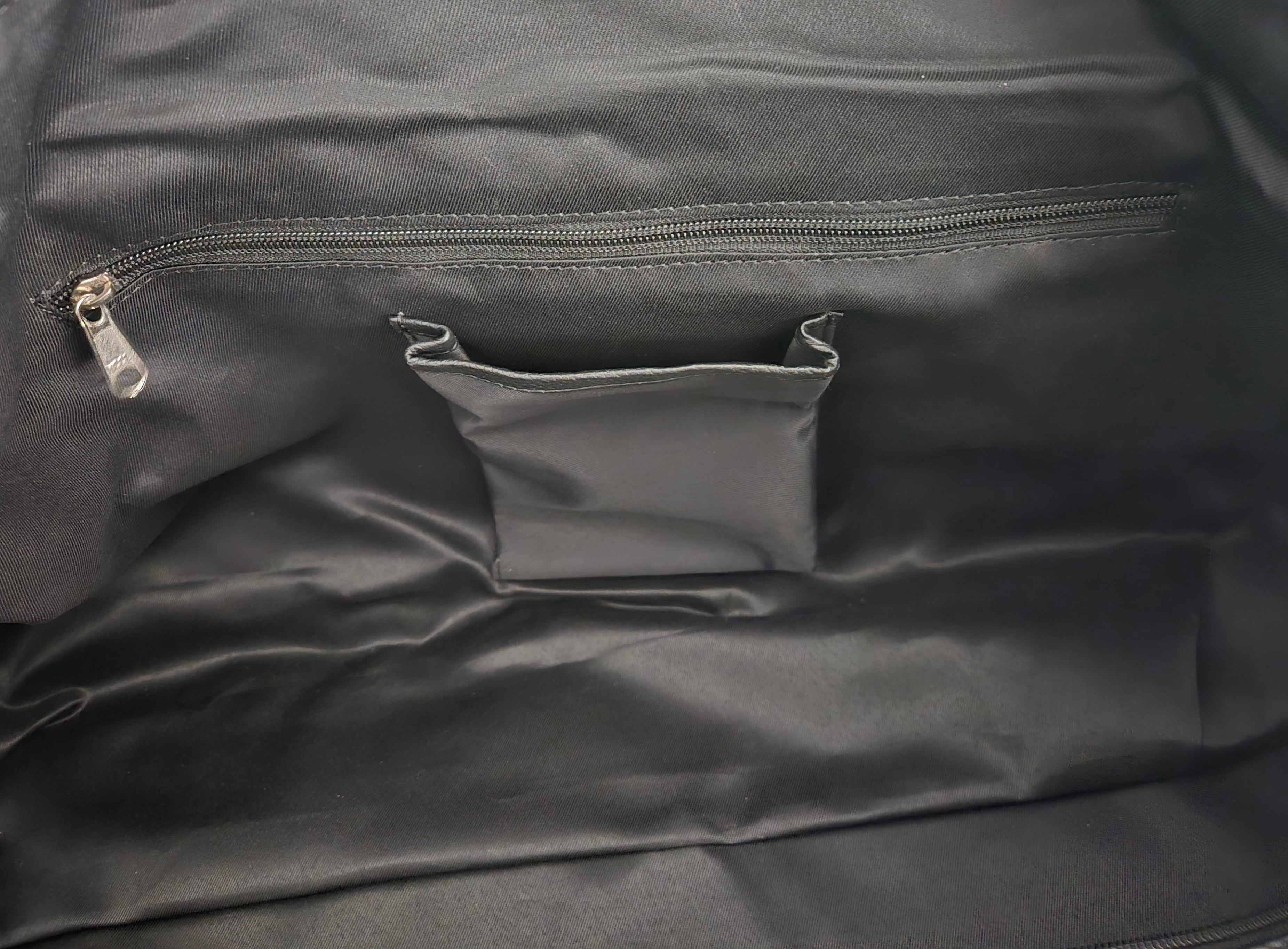 Close-up of a dark gray fabric with a zipper and pocket